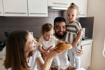 cheerful happy family gets pleasure from eating pancake, close up photo, leisure, pastime