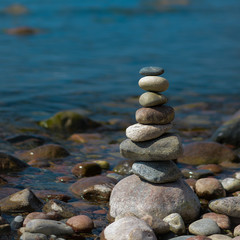 Pyramid of stones in the evening.On the sea shore a pyramid of stones. Dream on the beach