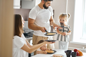 talented husband treting his family with yummy pancakes in the morning, daily life, free time,...