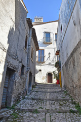 Fototapeta na wymiar The road between the old houses of a village in the mountains of southern Italy