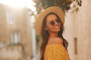 Summer portrait of pretty stylish girl. Young fashionable woman in yellow dress, sunglasses and...