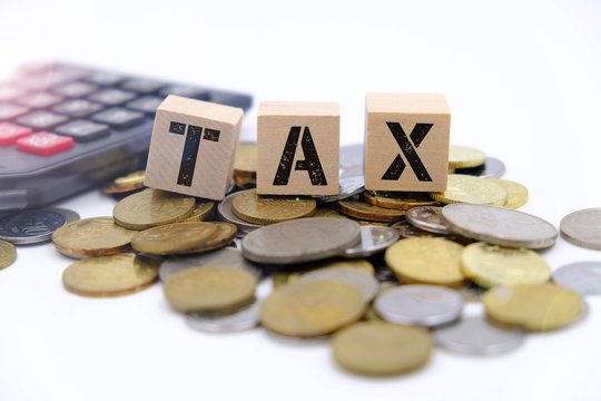Tax conceptual image over coin