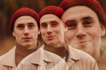 Multiple exposure. Traveler in a raincoat and a red knitted hat. Loneliness. Psychology