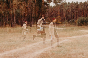 Multiple exposure. Traveler in a raincoat and a red knitted hat. Loneliness. Psychology