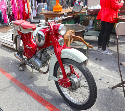 MUNICH, GERMANY - Bright red vintage motorcycle Zuendapp on sell at the open air giant flea market (Riesenflohmarkt) in Munich the biggest flea market of Bavaria. You find everything for every budget