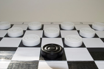 black checker attacks white