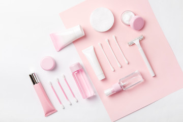 Face care products (tonic or lotion, serum, cream, micellar water, cotton pads and sticks, shaver) on powder background. Freshness and body care. Skin care and anti-age care. Female everyday cosmetics