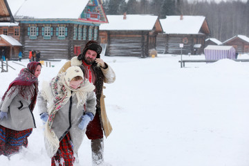 Couple in traditional winter costume of peasant in russia