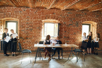 active little businesss childres discussing the projext, plan, preparing a presentation, working process, atmosphere