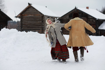 Couple in traditional winter costume of peasant in russia