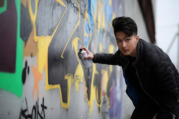 Asian young man on the street posing at the camera