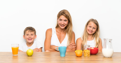 Mother with her two children having breakfast