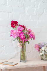 Flowers in vase over white wall