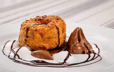 chocolate papanasi with a light background