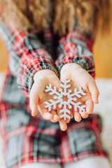 curly girl holding snowflake flaunting hands christmas