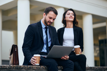 clever student helps his girlfriend to prepare for a conference, amn fixing a computer to his colleague. close up photo