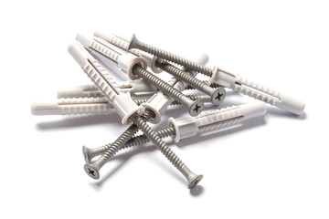 Plastic dowel and self-tapping screw on white background