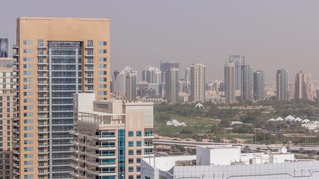 Dubai Golf Course with a cityscape of Gereens and tecom districts at the background aerial timelapse. Top view from Dubai marina
