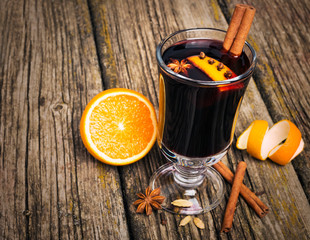 Christmas mulled wine in glass cup on a wooden table