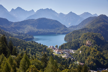 Fototapeta na wymiar Bright blue lake in the forest and mountain range