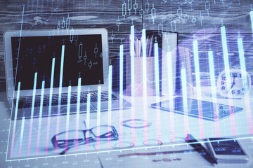 Double exposure of graph and financial info and work space with computer background. Concept of international online trading.