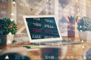 Financial graph colorful drawing and table with computer on background. Multi exposure. Concept of international markets.