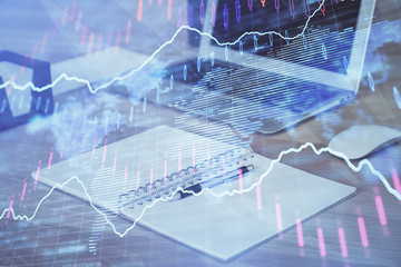 Double exposure of forex chart and work space with computer. Concept of international online trading.
