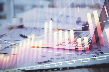 Forex Chart hologram on table with computer background. Multi exposure. Concept of financial markets.