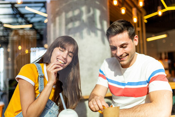 young couple eating food at restaurant