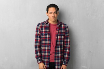 Obraz premium Man over grunge wall with sad and depressed expression