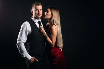 sexual woman seducting a businessman. isolated black background, studio shot,copy space. seductive art. close up portrait, studio shot