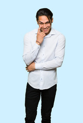 Handsome man looking to the front over isolated blue background