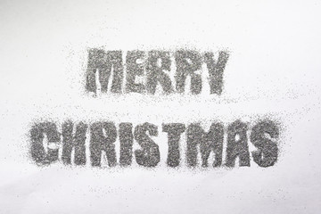 Christmas inscription in silver sequins on white background