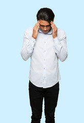 Handsome man unhappy and frustrated with something over isolated blue background