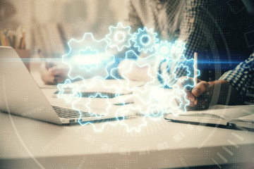 Multi exposure of businessman working on laptop on background. International business hologram in front. Concept of success.