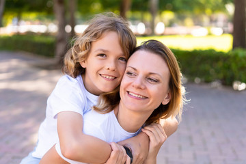 Fototapeta premium Happy mother and son in a park