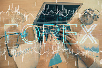 Multi exposure of forex graph with man working on computer on background. Concept of market analysis.