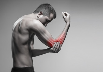 Man holds his elbow by the hand. Pain zone in the arm and bone illustration
