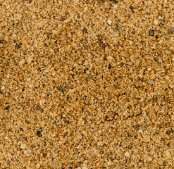 Vue macro d'une texture de sable orange et jaune avec gravillons