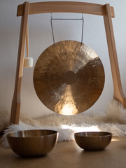 Golden Gong in a wooden stand for sound healing session