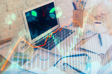 Financial graph colorful drawing and table with computer on background. Double exposure. Concept of international markets.
