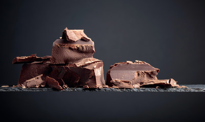 Black chocolate on a dark background.