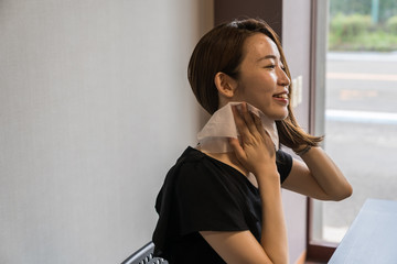 ハンズフリー扇風機を使う若い女性
