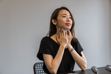 ハンズフリー扇風機を使う若い女性