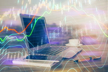 Forex market graph hologram and personal computer on background. Double exposure. Concept of investment.