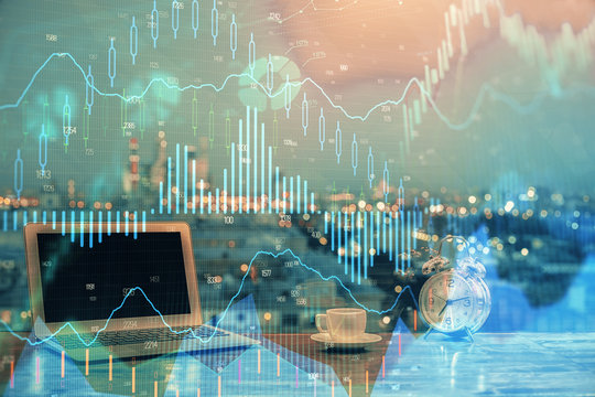 Double exposure of chart and financial info and work space with computer background. Concept of international online trading.