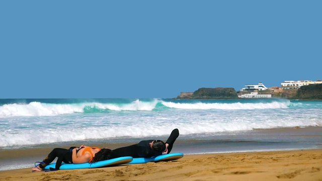 El Cotillo, two surfer relaxing on the beach on a sunny day