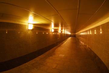 Photography of the city underground passage. Street lamps in golden lights.