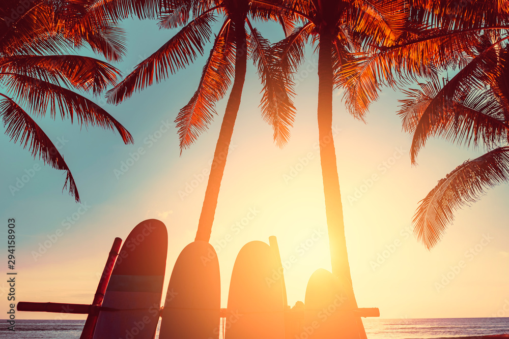 Wall mural surfboard and palm tree on beach background.