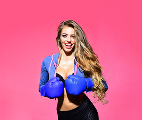 MMA. Female fighter. Smiling woman in boxing gloves training. Sportsman. Woman boxer fighting in gloves. Sport, boxing and fitness concept. Sporty sexy girl in boxing gloves. Boxer woman.